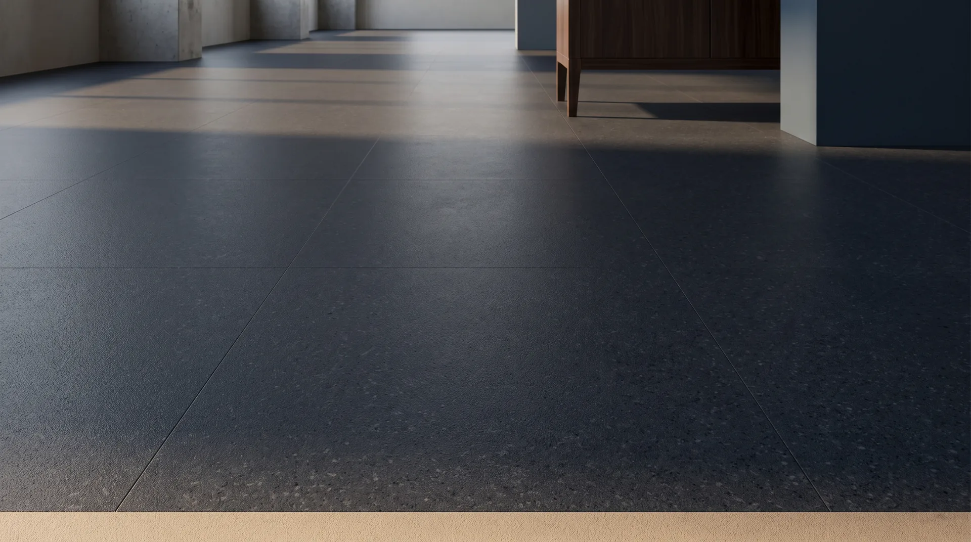 Near-black charcoal stone-effect flooring with a fine matte speckle across it