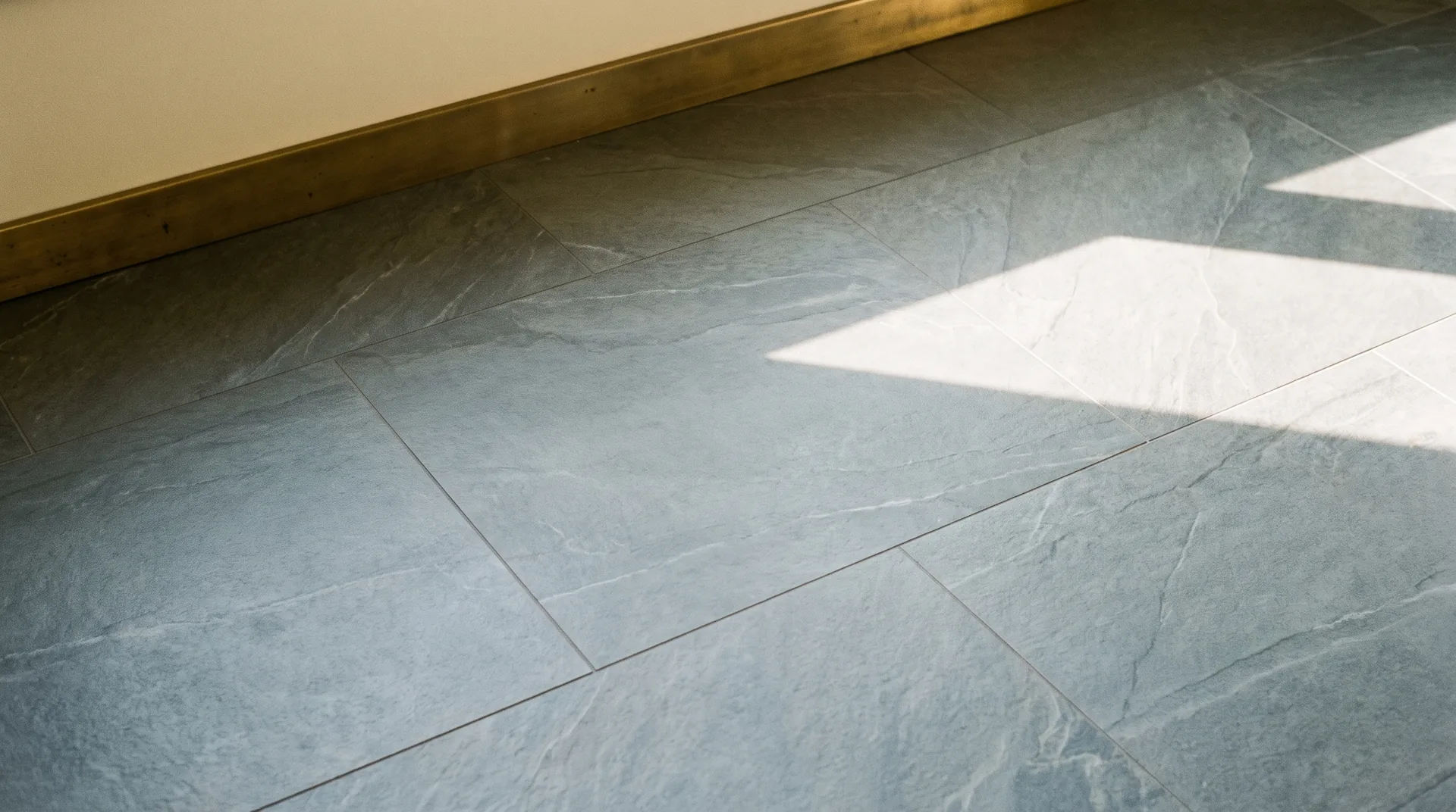 Cool grey slate-effect tiles with a lightly textured, riven stone surface